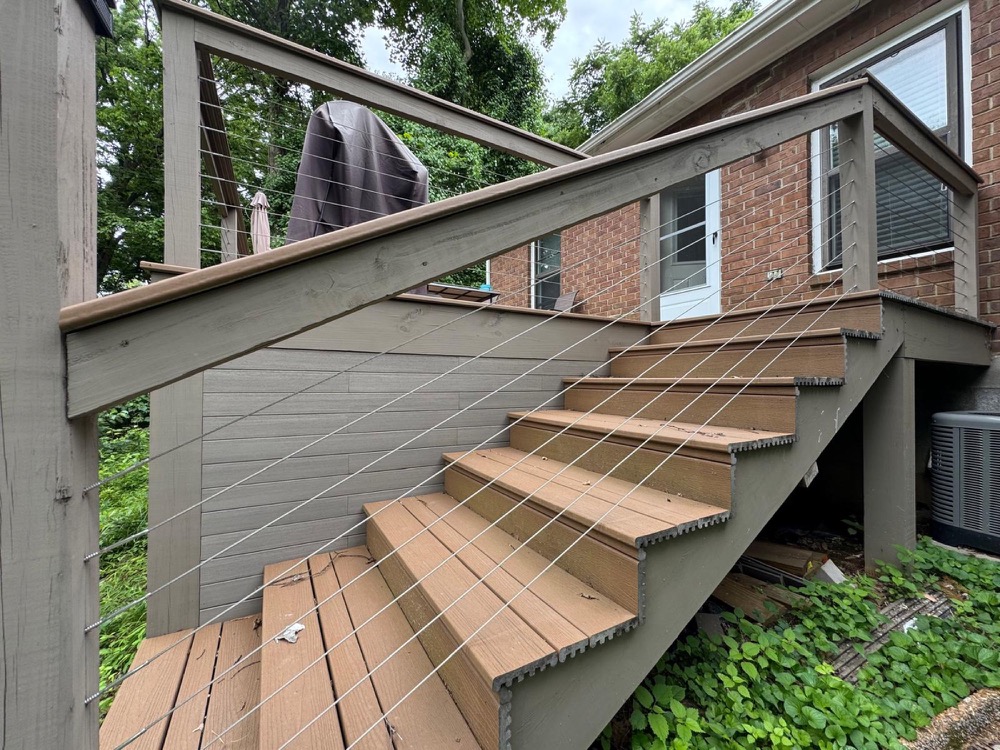 Southpine Design composite deck staircase with cable railing and a privacy wall