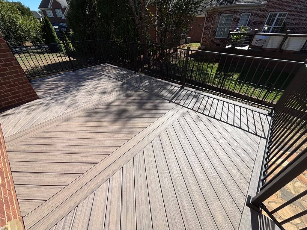 Diagonal deck boards with a border detail and black metal railing