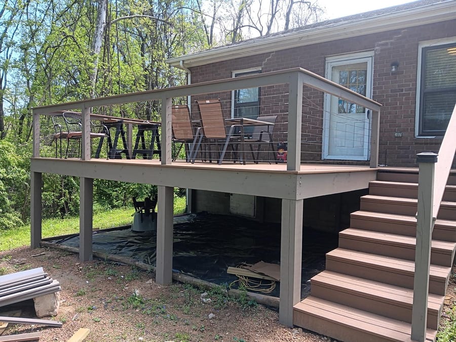 Southpine Design elevated composite deck with cable railing and a full staircase