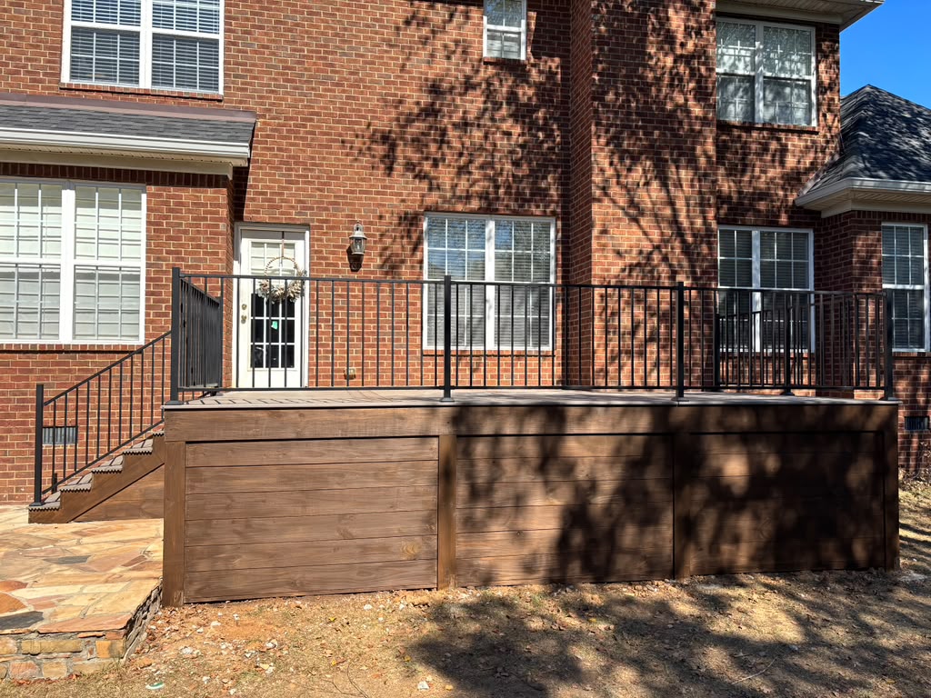 Completed deck with horizontal wood cladding and black railing