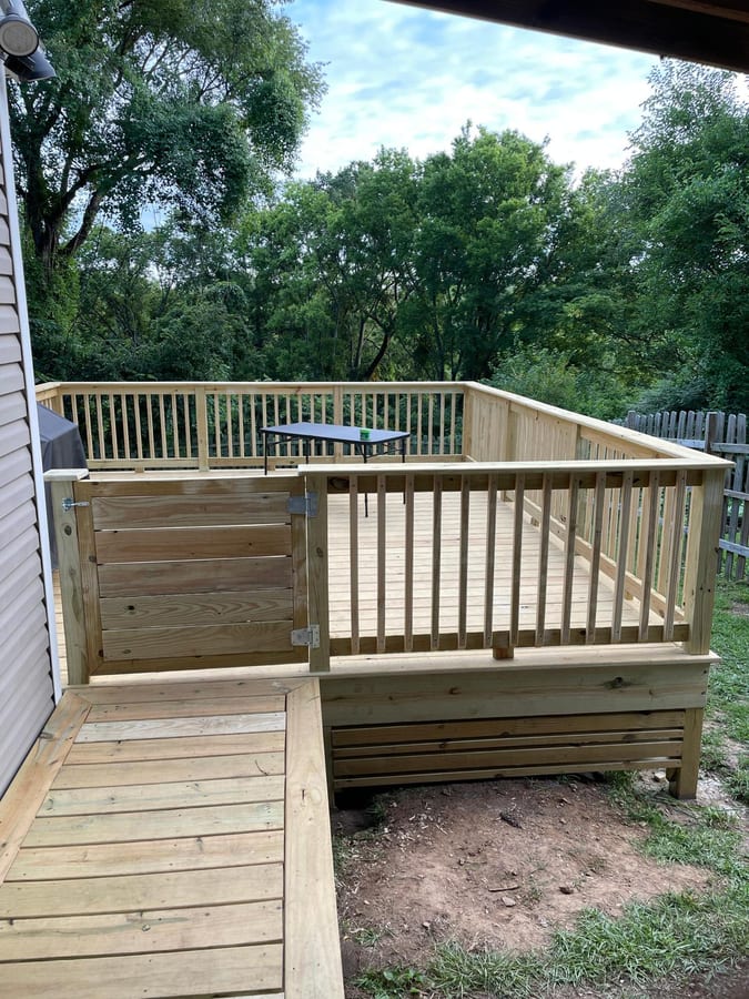 Southpine Design deck with vertical railing and a built-in gate