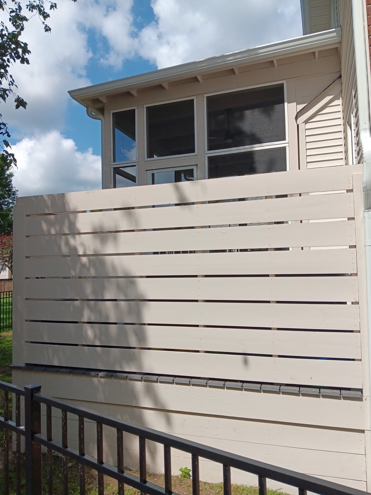 Southpine Design screened porch with a full-height horizontal privacy wall