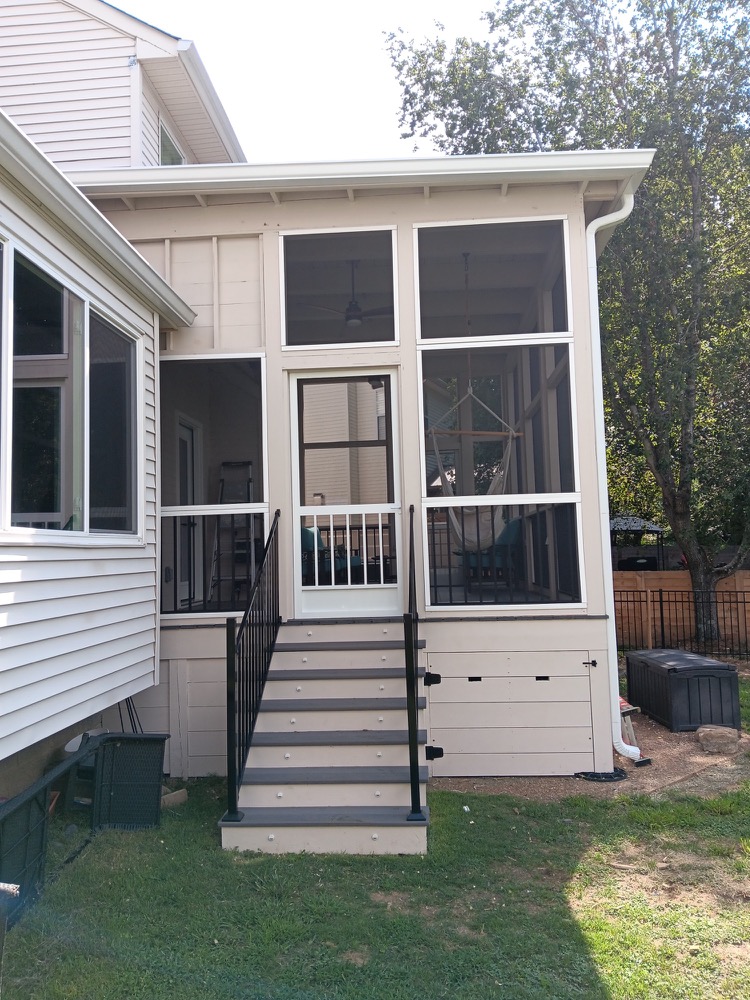 Southpine Design screened porch reached by a straight stair with black railing